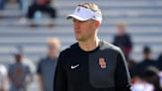 Sep 27, 2025; Champaign, Illinois, USA;  Southern California Trojans head coach Lincoln Riley before an NCAA football game with the Illinois Fighting Illini at Memorial Stadium. 