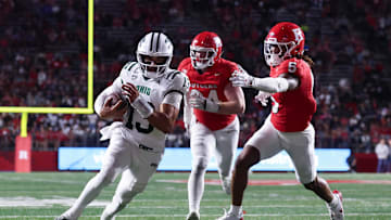 Aug 28, 2025; Piscataway, New Jersey, USA;  Ohio Bobcats quarterback Parker Navarro (13) scores a rushing touchdown as Rutgers Scarlet Knights defensive back Kaj Sanders (5) and defensive lineman Bradley Weaver (94) pursue during the second half at SHI Stadium. Mandatory Credit: Vincent Carchietta-Imagn Images