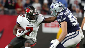 Jan 16, 2023; Tampa, Florida, USA; Tampa Bay Buccaneers running back Leonard Fournette (7) rushes the ball against the Dallas Cowboys linebacker Leighton Vander Esch (55) in the first half during the wild card game at Raymond James Stadium. Mandatory Credit: Kim Klement-USA TODAY Sports