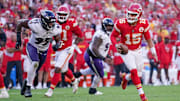 Sep 28, 2025; Kansas City, Missouri, USA; Kansas City Chiefs quarterback Patrick Mahomes (15) runs the ball as Baltimore Ravens linebacker Tavius Robinson (95) defends during the game at GEHA Field at Arrowhead Stadium. Mandatory Credit: Denny Medley-Imagn Images