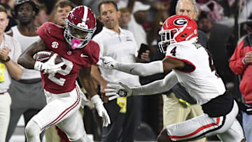 Sep 28, 2024; Tuscaloosa, Alabama, USA;  Alabama Crimson Tide wide receiver Ryan Williams (2) breaks a tackle by Georgia Bulldogs defensive back KJ Bolden (4) to score a touchdown that put Alabama ahead in the fourth quarter at Bryant-Denny Stadium. Alabama defeated Georgia 41-34. Mandatory Credit: Gary Cosby Jr.-Imagn Images