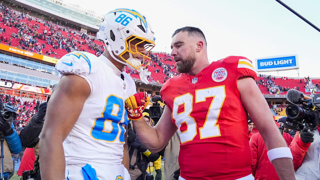 Oronde Gadsden II and Travis Kelce share words.