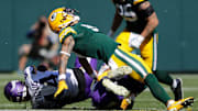 Green Bay Packers wide receiver Christian Watson (9) is injured as he is tackled by Minnesota Vikings on Sept. 29.