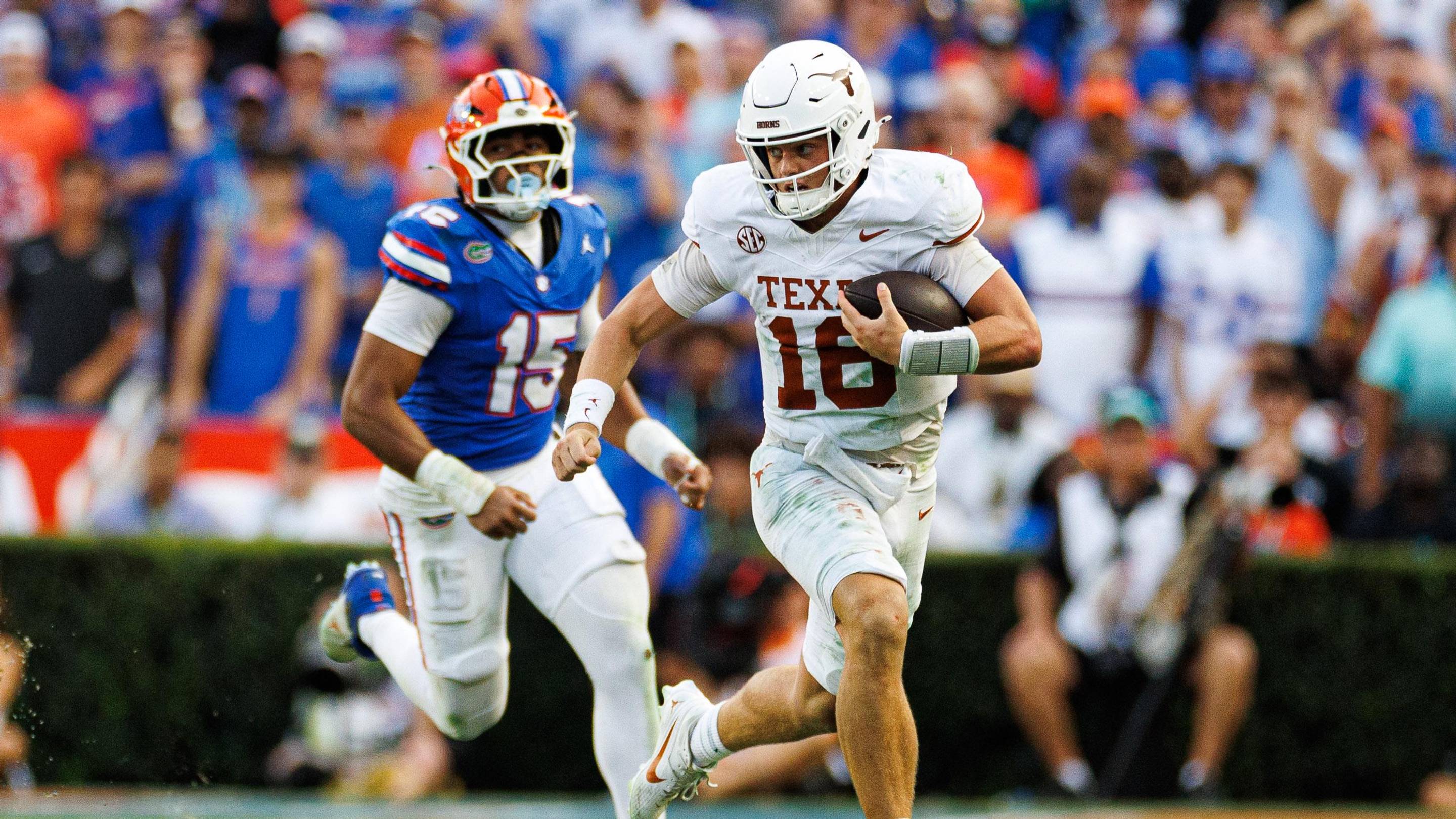 Oct 4, 2025; Gainesville, Florida, USA; Texas Longhorns quarterback Arch Manning (16) runs with the ball while Florida Gators defensive end Jayden Woods (15) chases during the second half at Ben Hill Griffin Stadium. Mandatory Credit: Matt Pendleton-Imagn Images