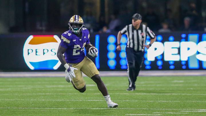 Former Huskies running back Adam Mohammed carries the ball during Washington's 70-10 Week 2 win over the UC Davis Aggies.