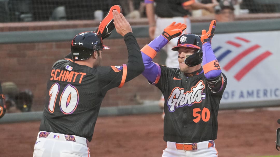 Jun 24, 2025; San Francisco, California, USA;  San Francisco Giants second base Christian Koss (50) celebrates with first base Casey Schmitt (10) after hitting a home run against the Miami Marlins during the fifth inning at Oracle Park. Mandatory Credit: Ed Szczepanski-Imagn Images