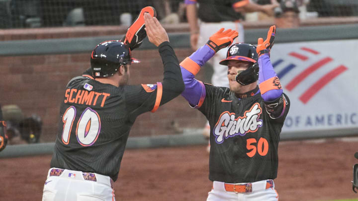 Jun 24, 2025; San Francisco, California, USA;  San Francisco Giants second base Christian Koss (50) celebrates with first base Casey Schmitt (10) after hitting a home run against the Miami Marlins during the fifth inning at Oracle Park. Mandatory Credit: Ed Szczepanski-Imagn Images