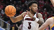 Nov 4, 2024; Louisville, Kentucky, USA;  Louisville Cardinals guard Koren Johnson (3) looks to pass again Morehead State Eagles guard Kade Ruegsegger (3) during the second half at KFC Yum! Center. Louisville defeated Morehead State 93-45. Mandatory Credit: Jamie Rhodes-Imagn Images