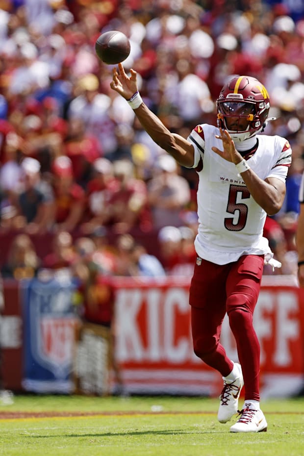 Washington Commanders quarterback Jayden Daniels throws a pass against New York Giants linebacker Brian Burns