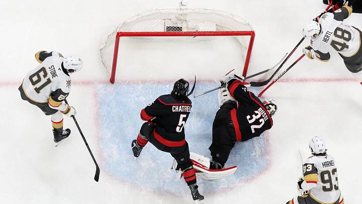 Jun 11, 2026; Raleigh, North Carolina, USA; Carolina Hurricanes goaltender Brandon Bussi (32) freezes the puck against Vegas Golden Knights center Tomas Hertl (48) during the third period in game five of the 2026 Stanley Cup Final at Lenovo Center. Mandatory Credit: Nathan Ray Seebeck-Imagn Images
