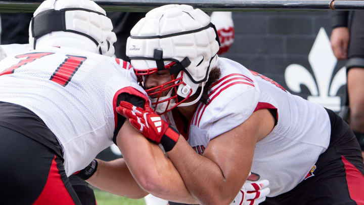 University of Louisville offensive linemen Michael Gonzalez (68) and Monroe Mills (71) run a drill during their second practice on Friday, Aug. 2, 2024 at L&N Federal Credit Union Stadium.