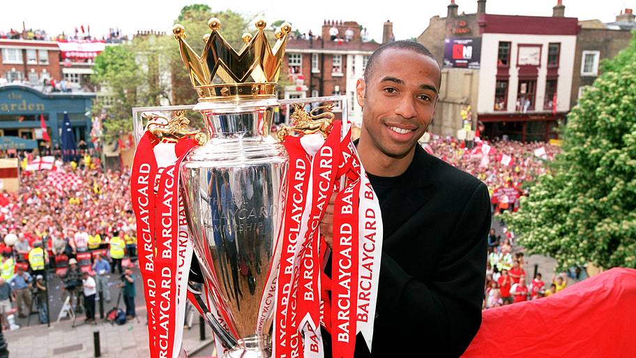 Thierry Henry holding the Premier League trophy.