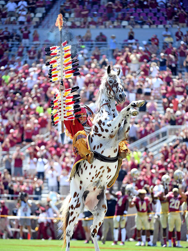 Florida State Seminoles symbol Chief Osceola and Renegade plant the spear at midfield