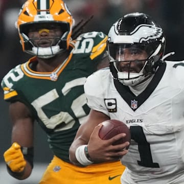 Sep 6, 2024; Sao Paulo, BRA; Philadelphia Eagles quarterback Jalen Hurts (1) runs from Green Bay Packers defensive end Rashan Gary (52) during the second half at Neo Quimica Arena. Mandatory Credit: Kirby Lee-Imagn Images