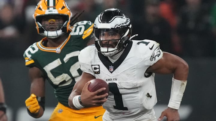 Sep 6, 2024; Sao Paulo, BRA; Philadelphia Eagles quarterback Jalen Hurts (1) runs from Green Bay Packers defensive end Rashan Gary (52) during the second half at Neo Quimica Arena. Mandatory Credit: Kirby Lee-Imagn Images