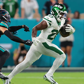 Sep 29, 2025; Miami Gardens, Florida, USA; New York Jets running back Breece Hall (20) rushes the ball against the Miami Dolphins during the first half at Hard Rock Stadium. Mandatory Credit: Sam Navarro-Imagn Images