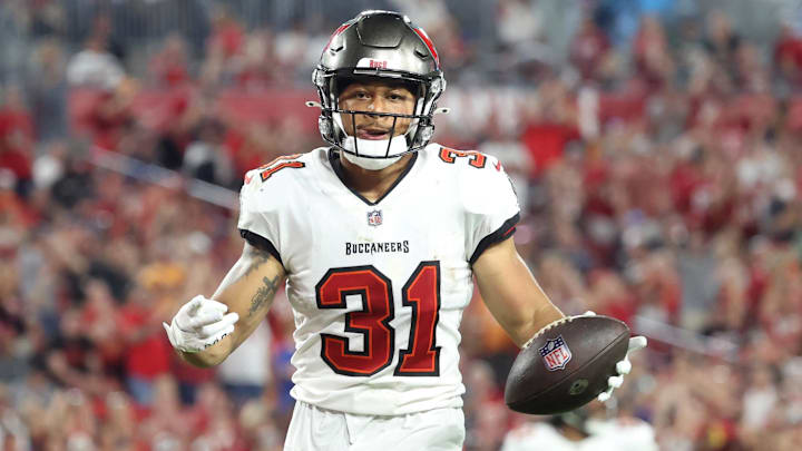 Jan 9, 2022; Tampa, Florida, USA; Tampa Bay Buccaneers safety Antoine Winfield Jr. (31) recovers the ball the ball against the Carolina Panthers during the second half at Raymond James Stadium. Mandatory Credit: Kim Klement-Imagn Images