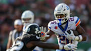 Aug 28, 2025; Tampa, Florida, USA; Boise State Broncos running back Sire Gaines (26) holds off South Florida Bulls cornerback De'Shawn Rucker (22) in the first quarter at Raymond James Stadium. 