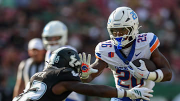 Aug 28, 2025; Tampa, Florida, USA; Boise State Broncos running back Sire Gaines (26) holds off South Florida Bulls cornerback De'Shawn Rucker (22) in the first quarter at Raymond James Stadium. 