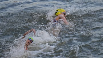 Jul 31, 2024; Paris, France; Taylor Knibb (USA) swims in the Seine River ahead of Miriam Casillas Garcia (ESP) in the women's triathlon during the Paris 2024 Olympic Summer Games at Grand Palais-Pont Alexandre III. Mandatory Credit: Andrew Nelles-USA TODAY Sports