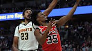 Oct 14, 2025; Denver, Colorado, USA; Chicago Bulls forward Isaac Okoro (35) scores against Denver Nuggets forward Cam Johnson (23) during the first half at Ball Arena. Mandatory Credit: Christopher Hanewinckel-Imagn Images
