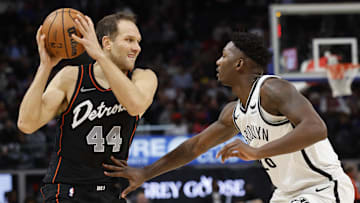 Dec 26, 2023; Detroit, Michigan, USA; Detroit Pistons forward Bojan Bogdanovic (44) is defended by Brooklyn Nets forward Dorian Finney-Smith (28) in the first half at Little Caesars Arena.