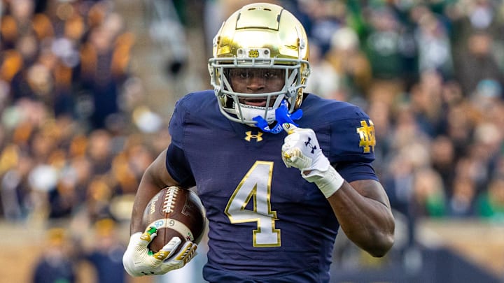 Nov 22, 2025; South Bend, Indiana, USA; Notre Dame Fighting Irish running back Jeremiyah Love (4) runs the ball against the Syracuse Orange during the first half at Notre Dame Stadium. Mandatory Credit: Michael Caterina-Imagn Images