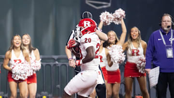 Dec 26, 2024; Phoenix, AZ, USA; Rutgers Scarlet Knights running back Ja'shon Benjamin (20) runs for a touchdown against the Kansas State Wildcats during the second half of the Rate Bowl at Chase Field. Mandatory Credit: Mark J. Rebilas-Imagn Images