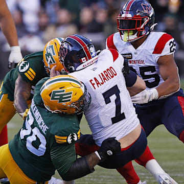 Jun 14, 2024; Edmonton, Alberta, CAN; Edmonton Elks defensive lineman Robert Nkemdiche (90) tackles Montreal Alouettes quarterback Cody Fajardo (7) during the second half at Commonwealth Stadium. Mandatory Credit: Perry Nelson-Imagn Images