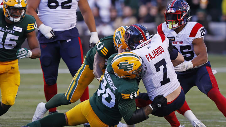 Jun 14, 2024; Edmonton, Alberta, CAN; Edmonton Elks defensive lineman Robert Nkemdiche (90) tackles Montreal Alouettes quarterback Cody Fajardo (7) during the second half at Commonwealth Stadium. Mandatory Credit: Perry Nelson-USA TODAY Sports