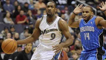 Washington Wizards point guard Gilbert Arenas dribbles by and is fouled by Orlando Magic point guard Jameer Nelson during the first half at the Verizon Center.  