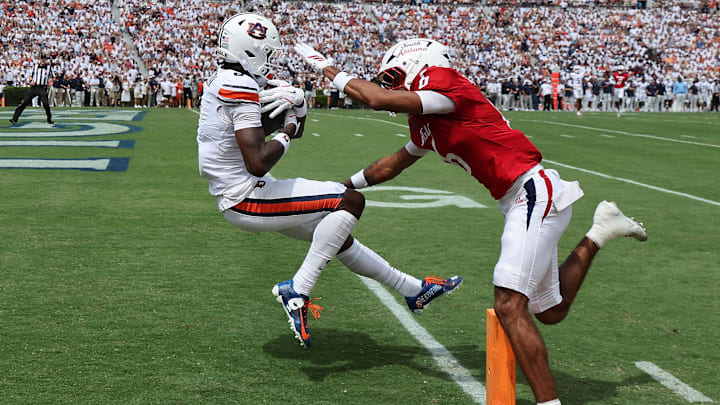 Sep 13, 2025; Auburn, Alabama, USA;  Auburn Tigers wide receiver Cam Coleman (8) makes a touchdown catch as South Alabama Jaguars cornerback Nehemiah Chandler (6) defends during the first quarter at Jordan-Hare Stadium. Mandatory Credit: John Reed-Imagn Images