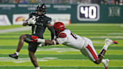 Nov 8, 2025; Honolulu, Hawaii, USA; San Diego State Aztecs defensive lineman Ryan Henderson (10) tries to pull down Hawaii Rainbow Warriors wide receiver Brandon White (1).