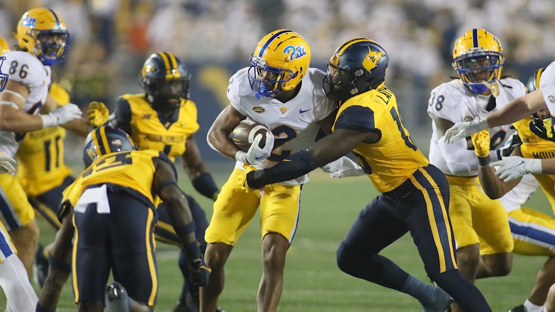 Pittsburgh Panthers Kenny Johnson (2) gets tackled by West Virginia Mountaineers Trey Lathan (19) during the second half at Milan Puskar Stadium in Morgantown, WV on September 16, 2023.