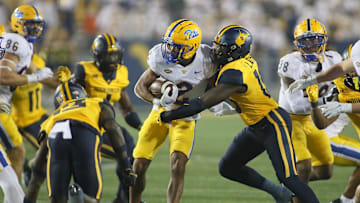 Pittsburgh Panthers Kenny Johnson (2) gets tackled by West Virginia Mountaineers Trey Lathan (19) during the second half at Milan Puskar Stadium in Morgantown, WV on September 16, 2023.
