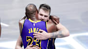 Apr 9, 2025; Dallas, Texas, USA;  Los Angeles Lakers guard Luka Doncic (77) celebrates with Los Angeles Lakers forward LeBron James (23) during the fourth quarter against the Dallas Mavericks at American Airlines Center. Mandatory Credit: Kevin Jairaj-Imagn Images