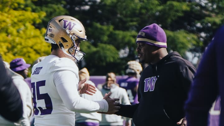 Grady Gross chats up a Husky coach during spring ball.