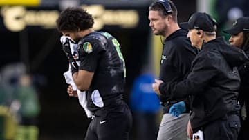 Oregon quarterback Dante Moore walks off the field holding his nose as the Oregon Ducks host the Wisconsin Badgers on Oct. 25, 2025, at Autzen Stadium in Eugene, Oregon.