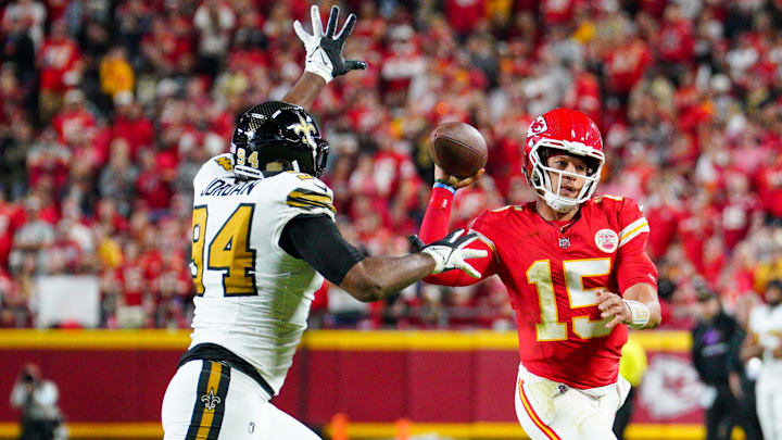 Oct 7, 2024; Kansas City, Missouri, USA; Kansas City Chiefs quarterback Patrick Mahomes (15) throws a pass as New Orleans Saints safety Johnathan Abram (24) defends  during the first half at GEHA Field at Arrowhead Stadium. Mandatory Credit: Denny Medley-Imagn Images