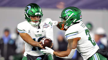 Dec 6, 2024; West Point, NY, USA; Tulane Green Wave quarterback Darian Mensah (10) hands off the ball to running back Shaadie Clayton-Johnson (2) during the first half against the Army Black Knights at Michie Stadium.