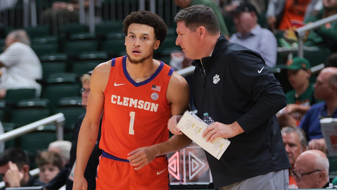 Dec 7, 2024; Coral Gables, Florida, USA; Clemson Tigers head coach Brad Brownell talks to guard Chase Hunter (1) during the first half against the Miami Hurricanes at Watsco Center.