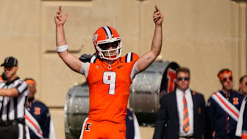 Believing he crossed the goal line, Illinois Fighting Illini quarterback Luke Altmyer (9)
