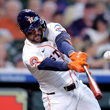 Houston Astros center fielder Chas McCormick (20) hits a single against the Colorado Rockies during the second inning at Daikin Park.