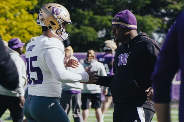 Grady Gross chats up a Husky coach during spring ball.