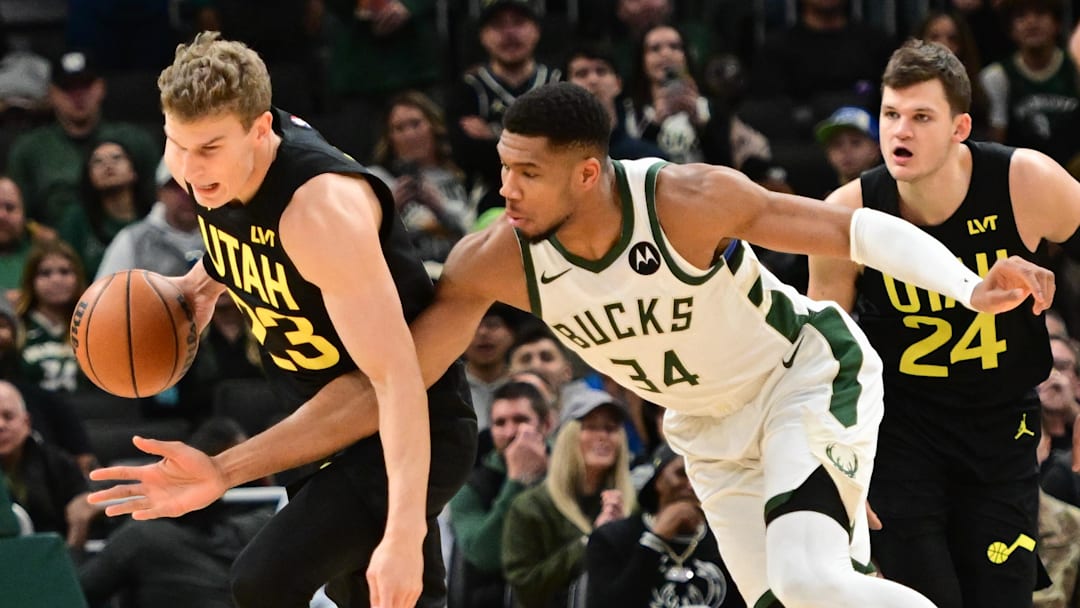 Nov 7, 2024; Milwaukee, Wisconsin, USA;  Milwaukee Bucks forward Giannis Antetokounmpo (34) tries to steal the ball from Utah Jazz forward Lauri Markkanen (23) in the first quarter at Fiserv Forum. Mandatory Credit: Benny Sieu-Imagn Images