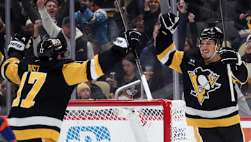 Jan 9, 2025; Pittsburgh, Pennsylvania, USA;  Pittsburgh Penguins right wing Rickard Rakell (right) celebrates his goal with right wing Bryan Rust (17) against the Edmonton Oilers during the first period at PPG Paints Arena. Mandatory Credit: Charles LeClaire-Imagn Images