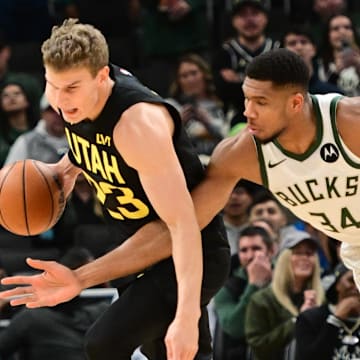 Nov 7, 2024; Milwaukee, Wisconsin, USA;  Milwaukee Bucks forward Giannis Antetokounmpo (34) tries to steal the ball from Utah Jazz forward Lauri Markkanen (23) in the first quarter at Fiserv Forum. Mandatory Credit: Benny Sieu-Imagn Images