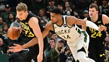 Nov 7, 2024; Milwaukee, Wisconsin, USA;  Milwaukee Bucks forward Giannis Antetokounmpo (34) tries to steal the ball from Utah Jazz forward Lauri Markkanen (23) in the first quarter at Fiserv Forum. Mandatory Credit: Benny Sieu-Imagn Images
