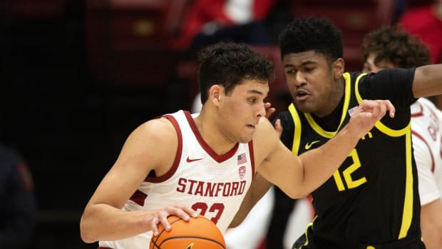 Stanford Cardinal forward Brandon Angel (23) drives past Oregon Ducks forward James Cooper (12) 