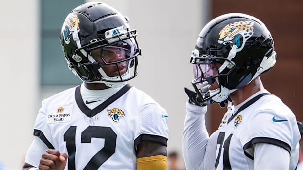 Jacksonville Jaguars wide receiver Travis Hunter (12) talks with teammate Jacksonville Jaguars cornerback Christian Braswell 